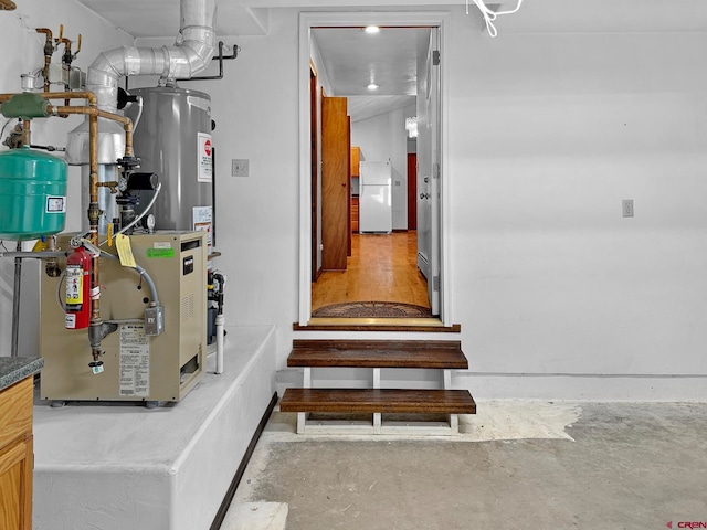 interior space featuring concrete flooring and gas water heater