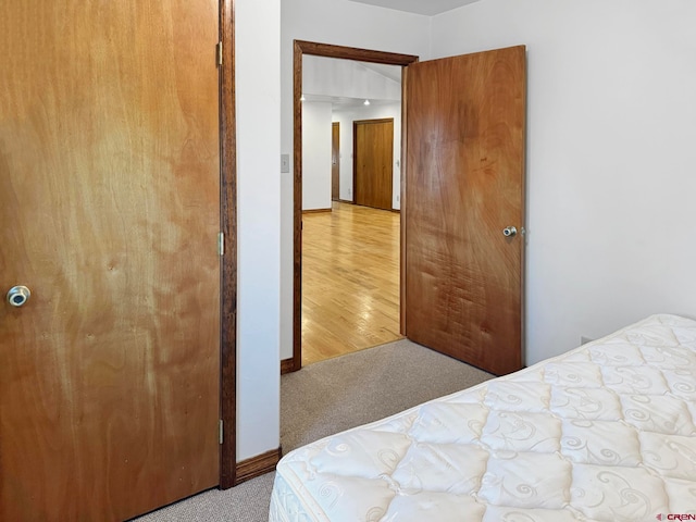 bedroom with light hardwood / wood-style floors and a closet