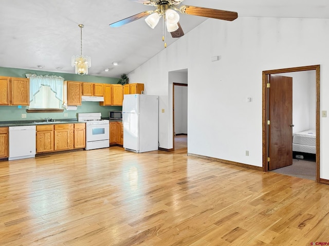 kitchen featuring pendant lighting, white appliances, light hardwood / wood-style flooring, and high vaulted ceiling