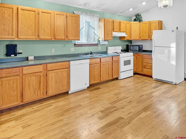 kitchen featuring vaulted ceiling, sink, light hardwood / wood-style floors, and white appliances