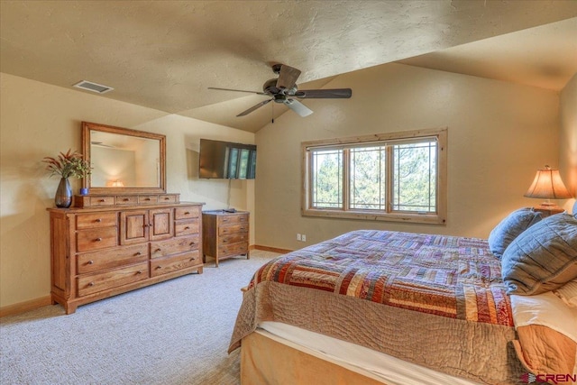 carpeted bedroom featuring a textured ceiling, ceiling fan, and vaulted ceiling