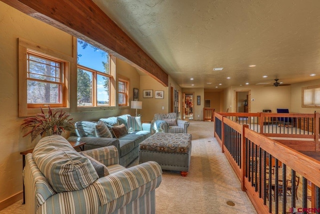 carpeted living room featuring a textured ceiling and ceiling fan