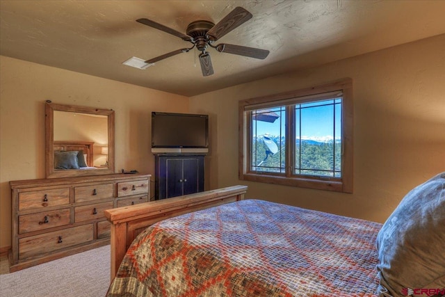 bedroom with ceiling fan and light colored carpet