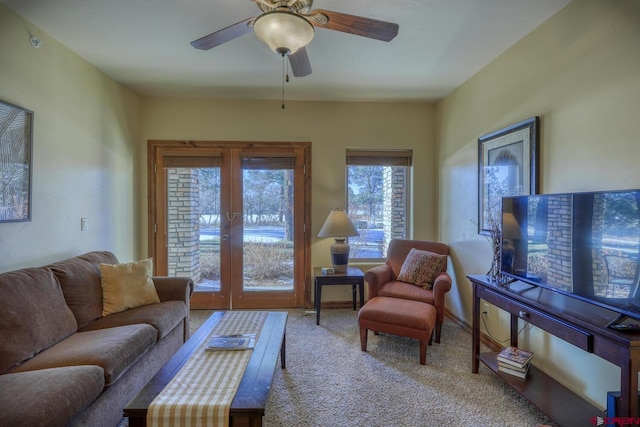 living room featuring french doors, light colored carpet, and ceiling fan