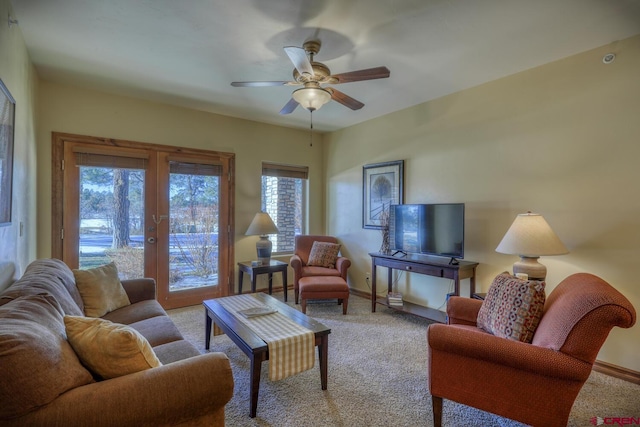 carpeted living room featuring french doors and ceiling fan