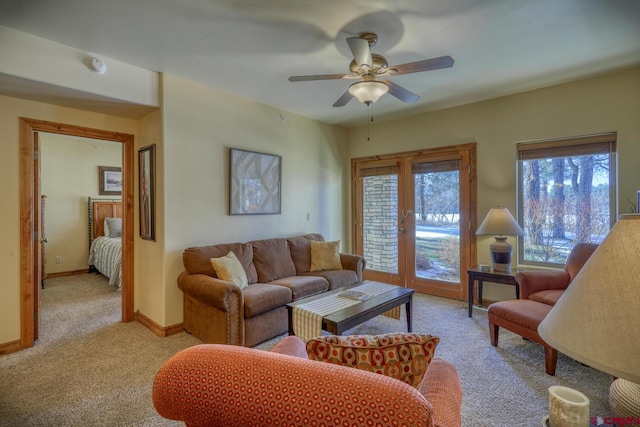 carpeted living room featuring french doors and ceiling fan