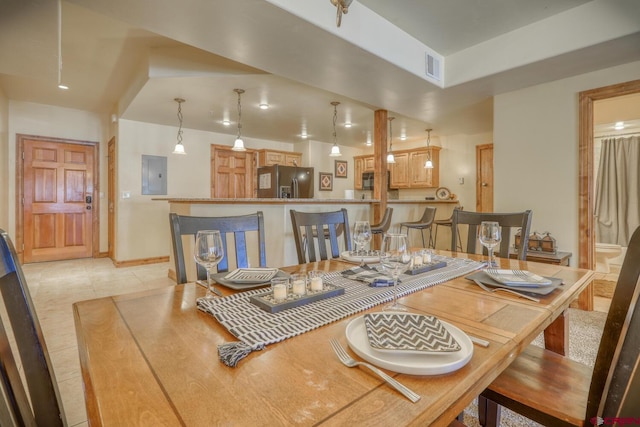 tiled dining space with electric panel