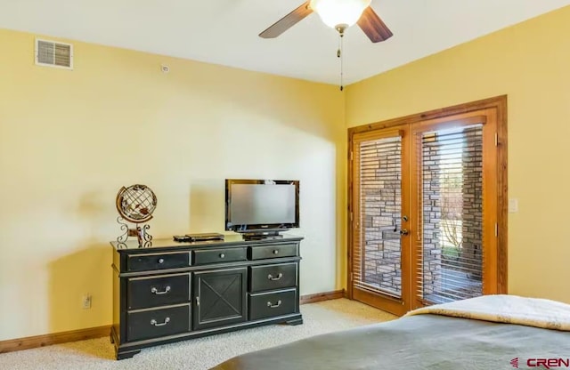 carpeted bedroom featuring access to exterior and ceiling fan