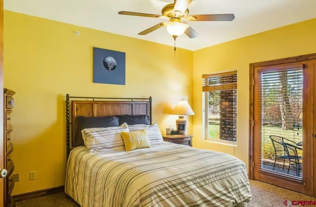 bedroom featuring ceiling fan, access to exterior, and multiple windows