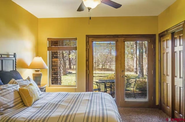 bedroom with access to exterior, french doors, ceiling fan, and carpet flooring