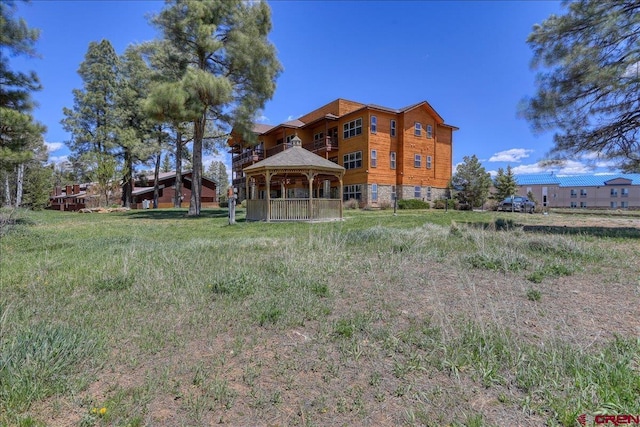 back of property with a gazebo