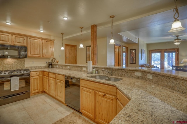 kitchen with pendant lighting, light brown cabinetry, sink, and black appliances