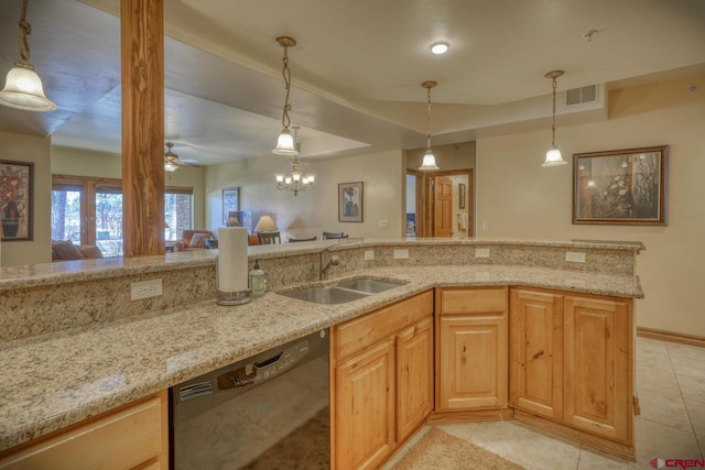 kitchen featuring pendant lighting, black dishwasher, sink, light tile patterned floors, and light stone counters