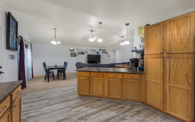 kitchen with ceiling fan with notable chandelier, decorative light fixtures, and light hardwood / wood-style flooring