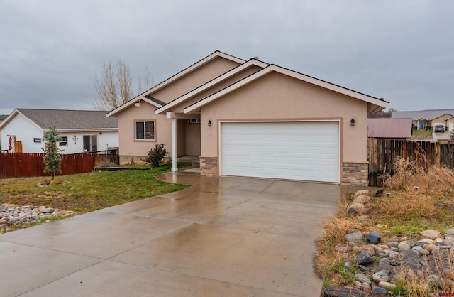 single story home with a garage and a front lawn