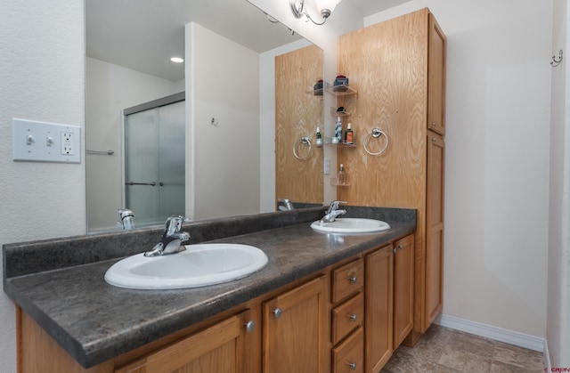 bathroom featuring vanity and an enclosed shower