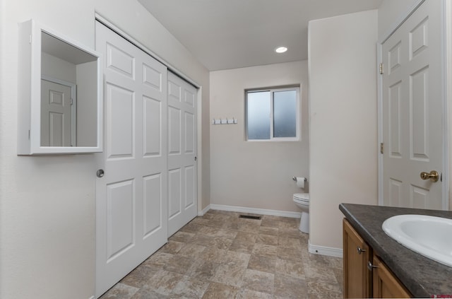 bathroom featuring vanity and toilet