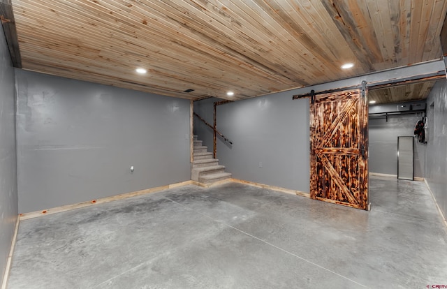 basement featuring a barn door and wooden ceiling