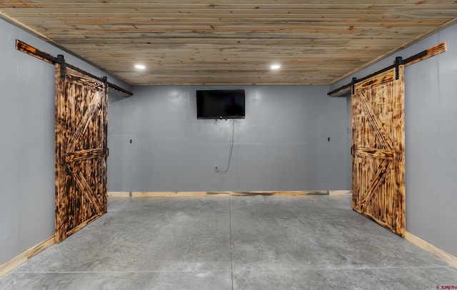 basement with a barn door and wood ceiling