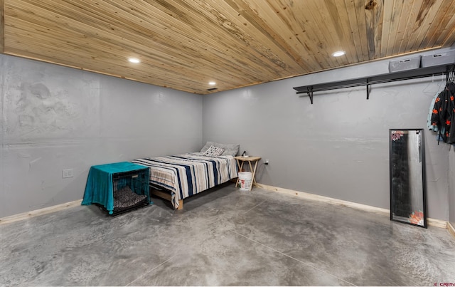 bedroom with wooden ceiling and concrete flooring