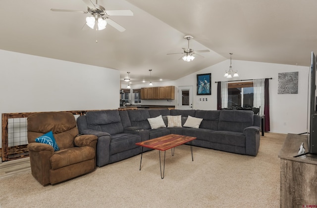 living room with ceiling fan with notable chandelier, light colored carpet, and vaulted ceiling