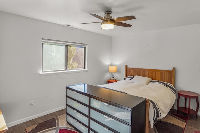 bedroom with ceiling fan and dark hardwood / wood-style floors