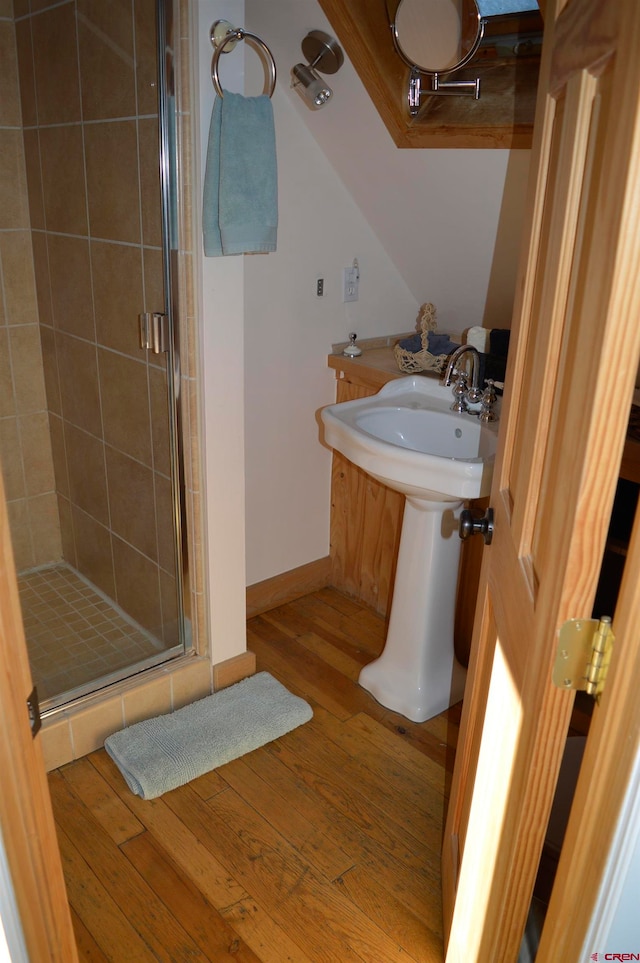 bathroom featuring wood-type flooring and a shower with door