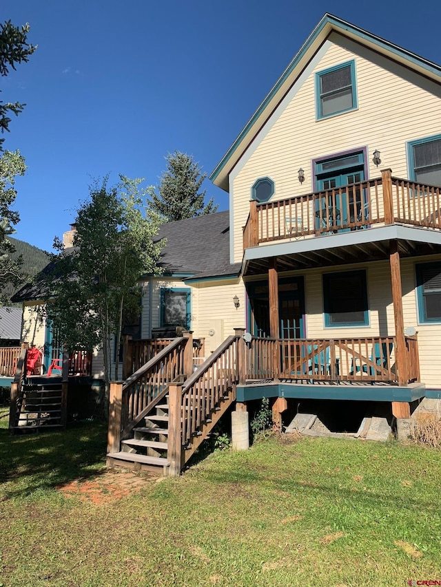 rear view of property featuring a yard