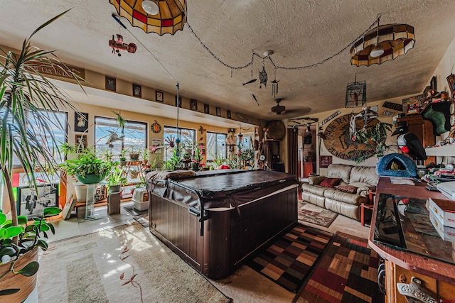 interior space featuring ceiling fan and a textured ceiling