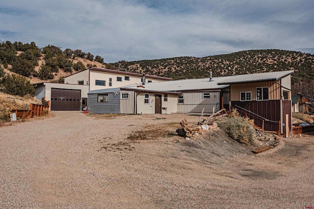 view of front of house with an outbuilding, a mountain view, and a garage