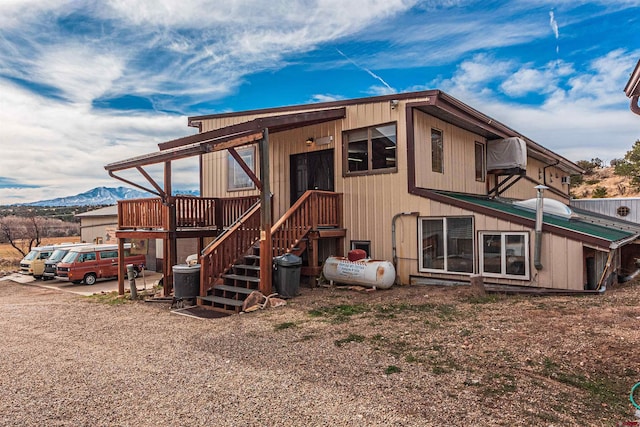 rear view of house featuring a mountain view