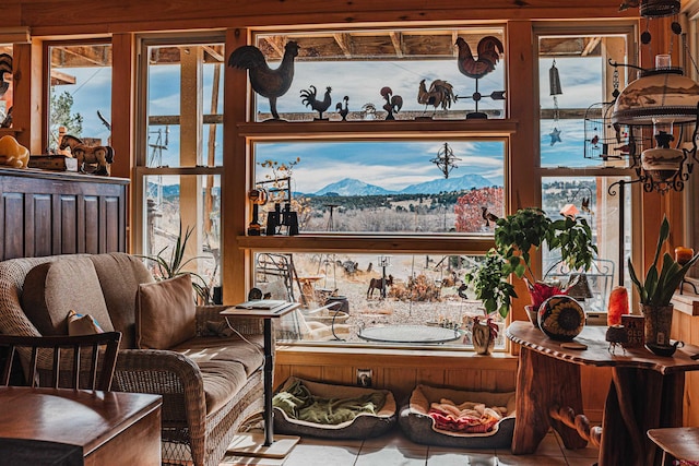 interior space with a mountain view, tile patterned floors, and a healthy amount of sunlight