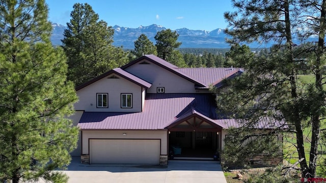 view of front facade featuring a mountain view and a garage