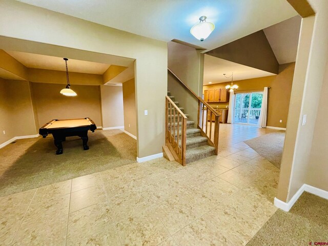 interior space with lofted ceiling, light carpet, pool table, and an inviting chandelier