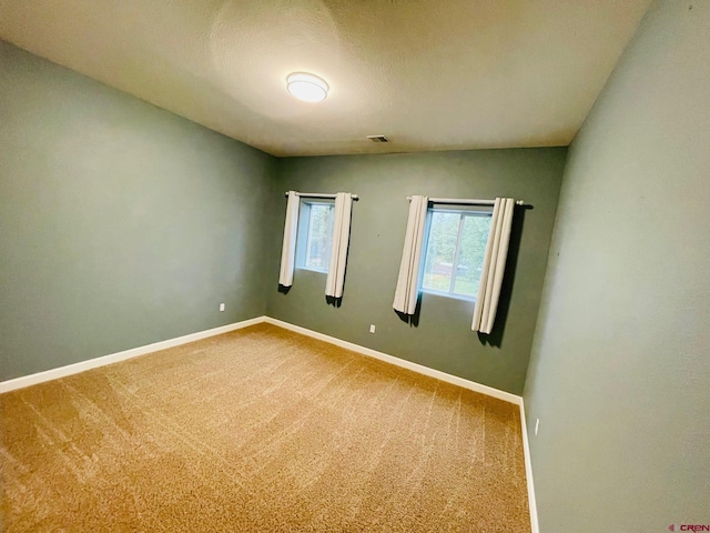 spare room with carpet floors and a textured ceiling