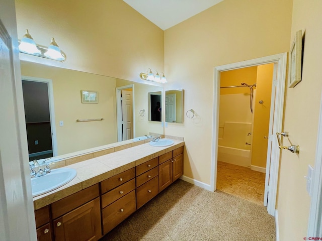 bathroom with vanity and shower / washtub combination