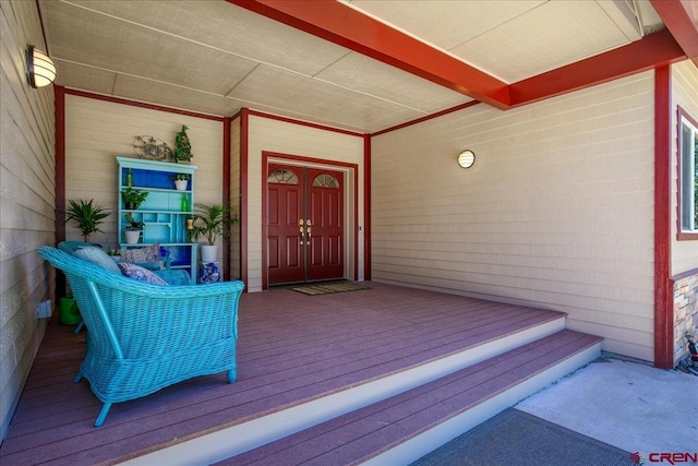 view of exterior entry with covered porch