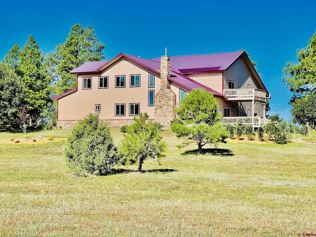 rear view of house featuring a lawn