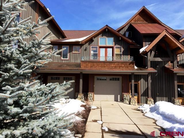 view of front of home with a balcony and a garage