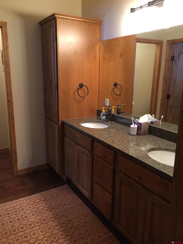 bathroom featuring vanity and wood-type flooring