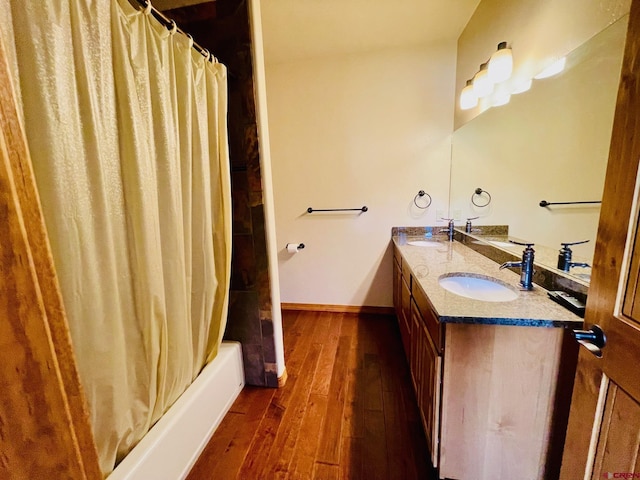 bathroom featuring vanity, wood-type flooring, and shower / bath combo