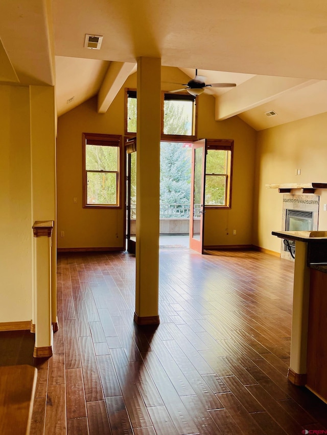 unfurnished living room featuring hardwood / wood-style floors, lofted ceiling with beams, and ceiling fan