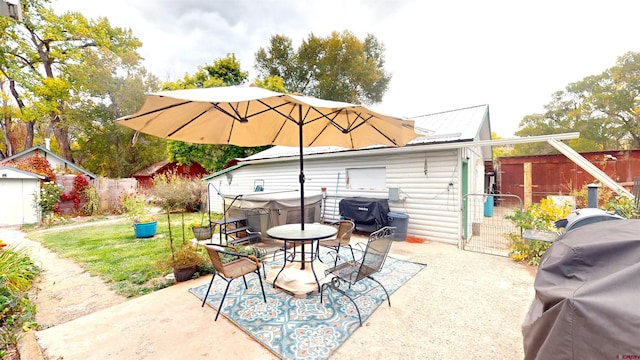 view of patio featuring a shed and grilling area