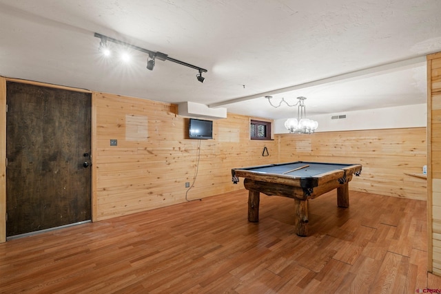 playroom with track lighting, wooden walls, hardwood / wood-style flooring, pool table, and a chandelier