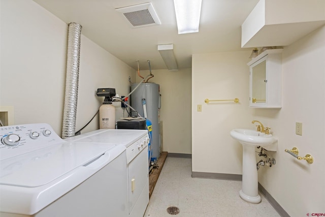 washroom featuring washing machine and dryer and water heater