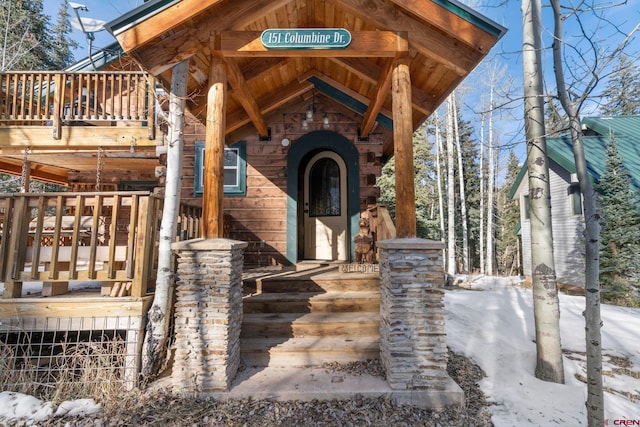 view of snow covered property entrance