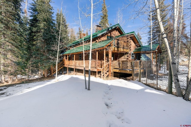 snow covered house with a deck