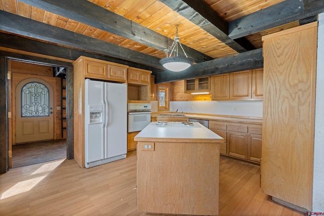 kitchen with light hardwood / wood-style floors, a center island, white appliances, and beam ceiling