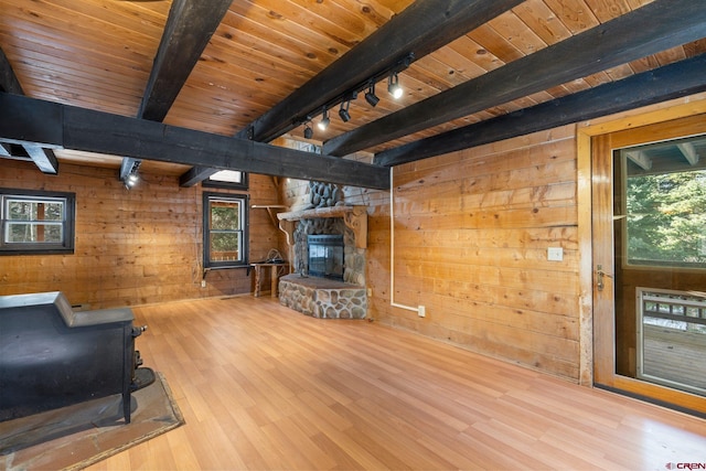 living room with wooden ceiling, rail lighting, wooden walls, hardwood / wood-style flooring, and beamed ceiling