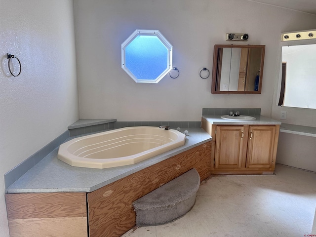 bathroom featuring vanity and a tub